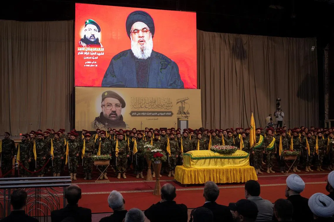 Lebanon's Hezbollah leader Sayyed Hassan Nasrallah speaking onscreen at the funeral of Hezbollah senior commander Fuad Shukr, who was killed in an Israeli strike.