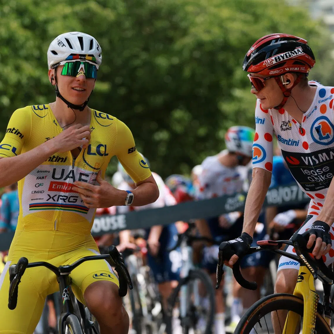 Cycling - Tour de France - Stage 14 - Mulhouse to Le Markstein Fellering - Mulhouse, France - July 18, 2026 UAE Team Emirates XRG's Tadej Pogacar, wearing the yellow jersey, and Team Visma | Lease a Bike's Jonas Vingegaard, wearing the polka-dot jersey, before the start of stage 14 REUTERS/Stephanie Lecocq