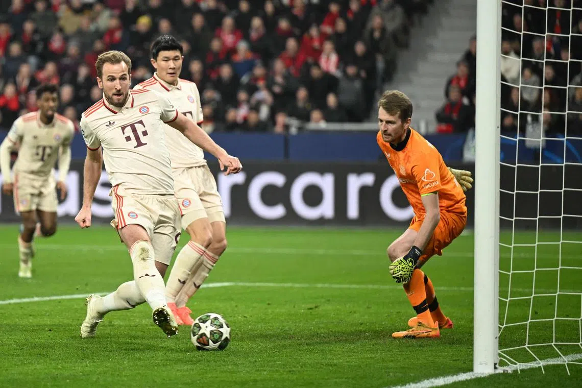 Bayern Munich's Harry Kane (left) scores the opening goal against Bayer Leverkusen.