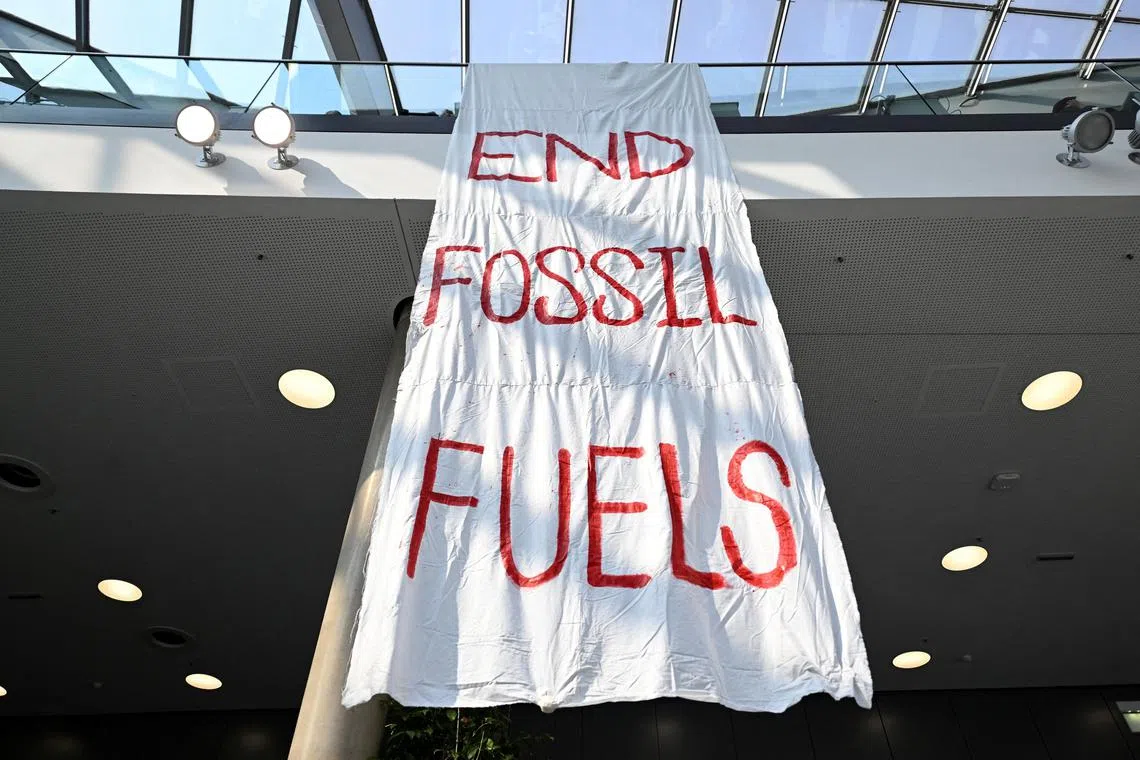 FILE PHOTO: A banner reads "End Fossil Fuels" at the Bonn Climate Change Conference in Bonn, Germany, June 8, 2023. REUTERS/Jana Rodenbusch/File Photo
