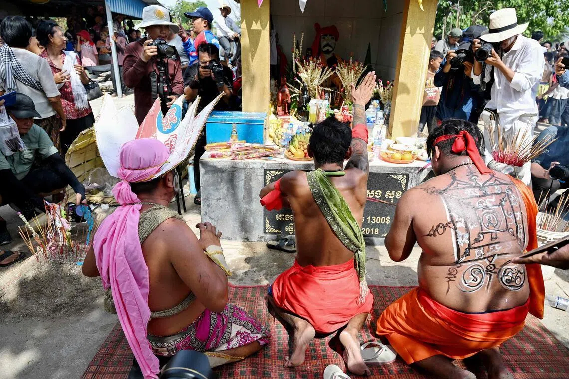 Cambodian revellers praying to the guardian spirit Pring Ka-Ek on the outskirts of Phnom Penh on May 21.