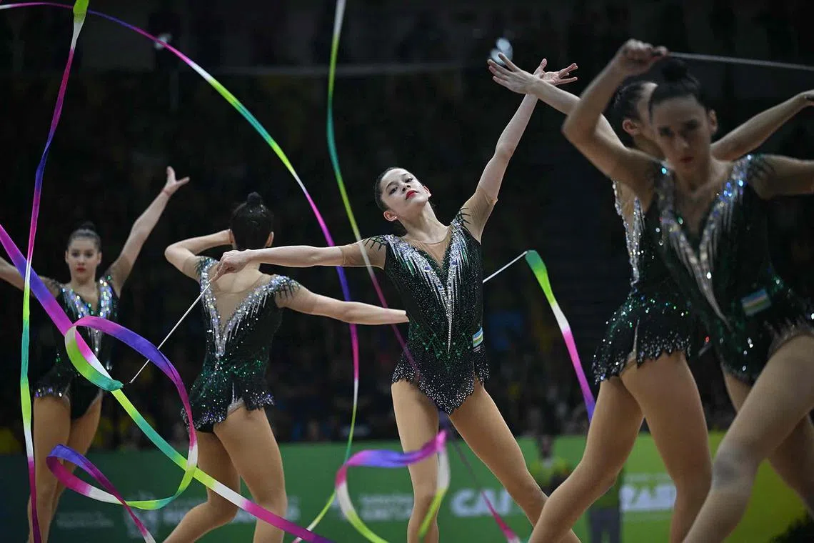 Uzbekistan's team compete in the five ribbons group final of the 41st FIG Rhythmic Gymnastics World Championships in Rio de Janeiro, Brazil on August 24, 2025. (Photo by Mauro PIMENTEL / AFP)