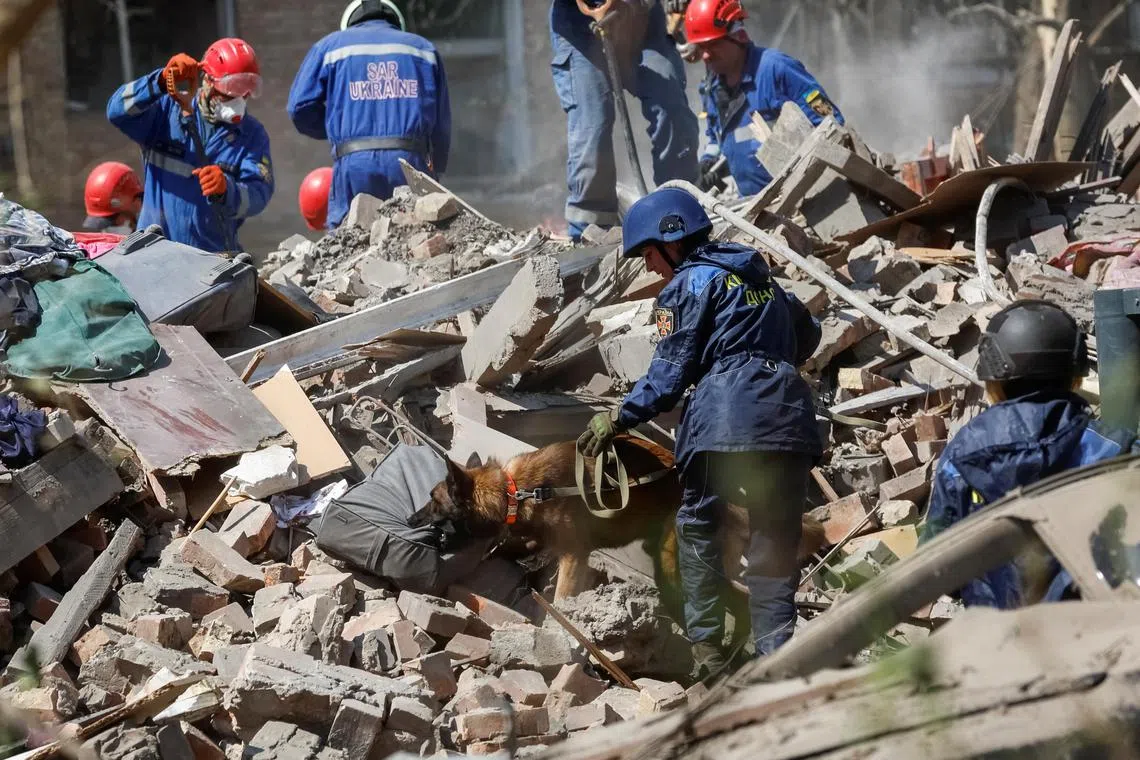 Rescuers searching for people who could still be under the rubble of a residential building, after an overnight missile strike on Kyiv, on April 24.