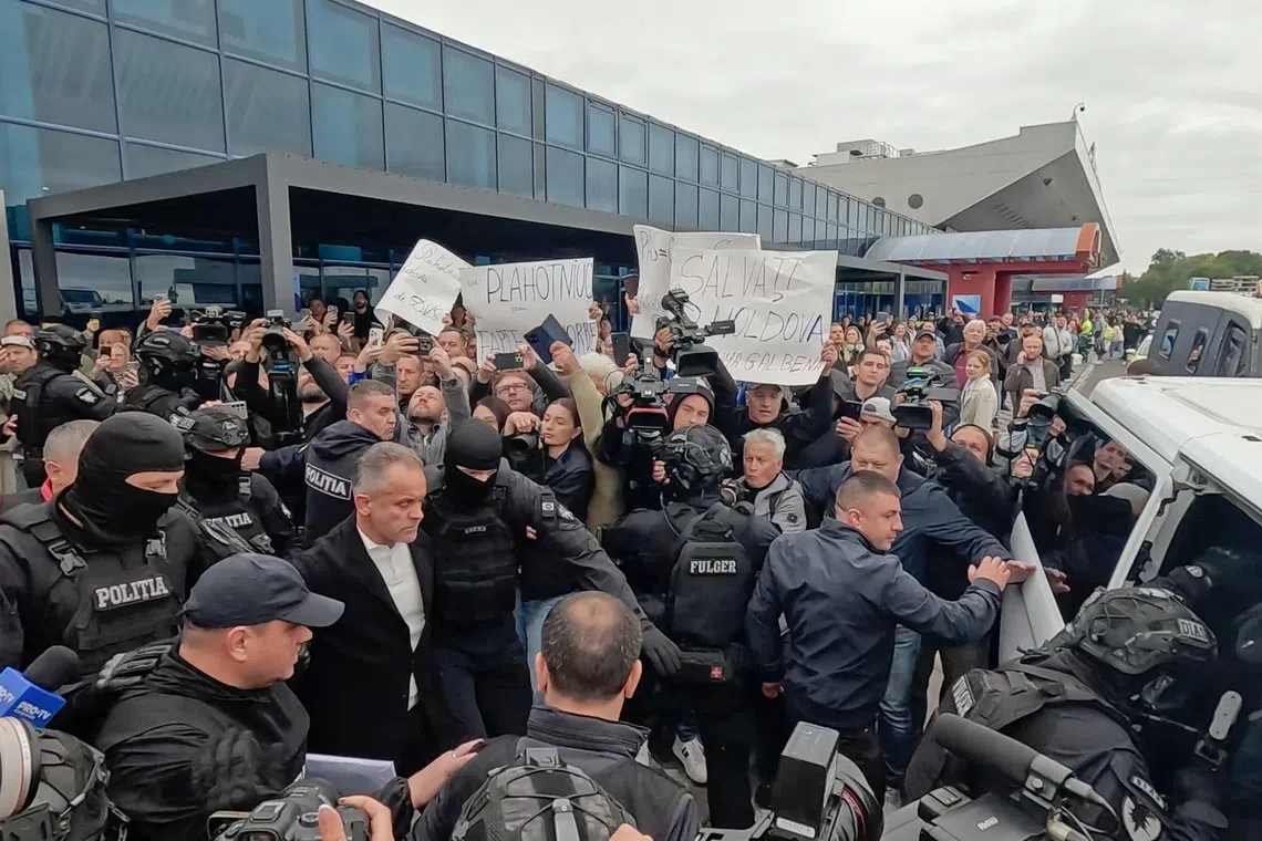 Vladimir Plahotniuc, a Moldovan former lawmaker and business magnate detained on a warrant linked to a fraud case and extradited from Greece, walks towards a minibus outside an airport upon his arrival in Chisinau, Moldova, September 25, 2025, in this still image taken from video. REUTERS/Vladislav Culiomza