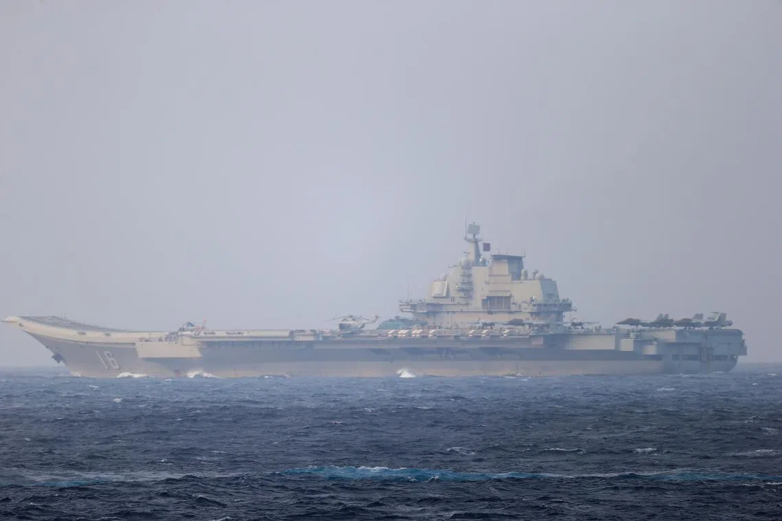 FILE PHOTO: Chinese aircraft carrier Liaoning sails through the Miyako Strait near Okinawa on its way to the Pacific in this handout photo taken by Japan Self-Defense Forces and released by the Joint Staff Office of the Defense Ministry of Japan on April 4, 2021. Joint Staff Office of the Defense Ministry of Japan/HANDOUT via REUTERS/File Photo