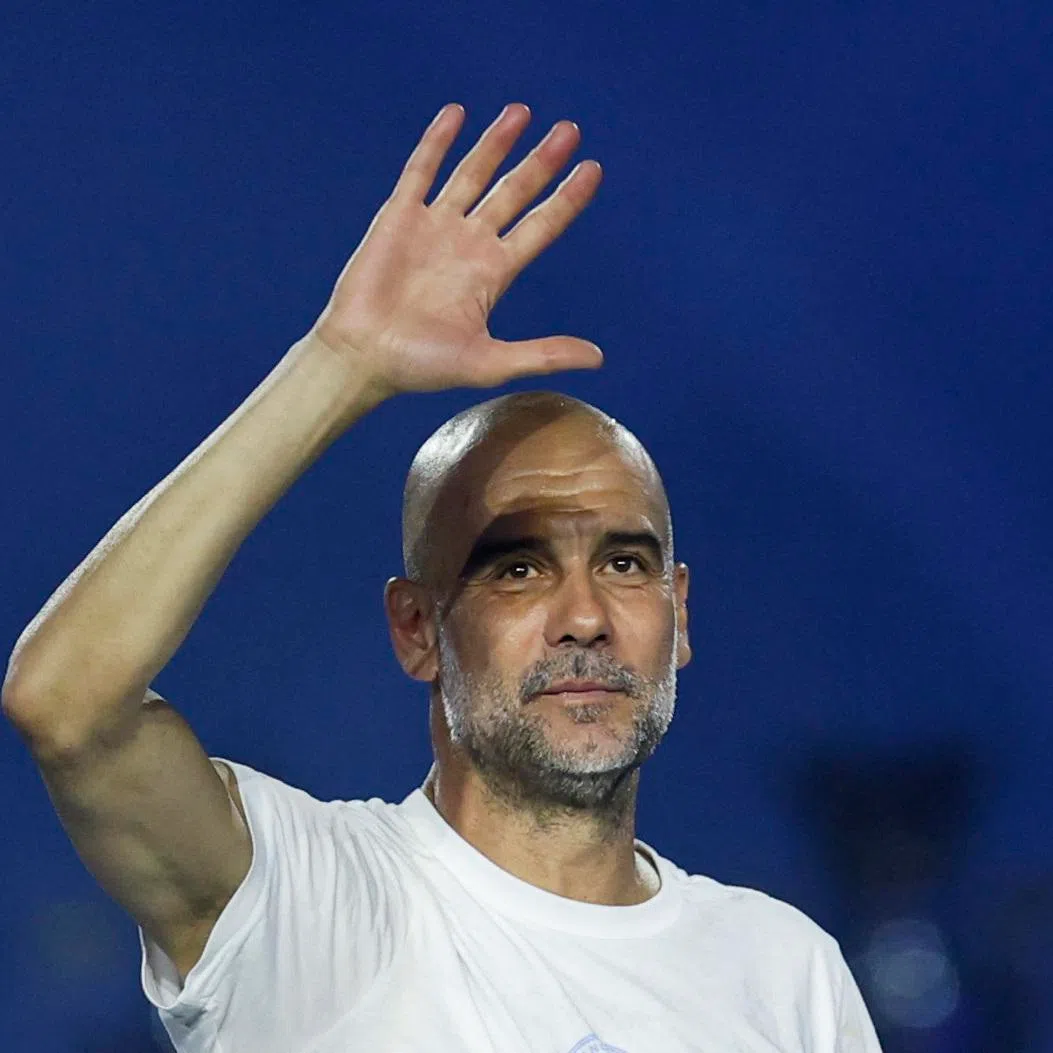 Soccer Football - Manchester City FA Cup and Carabao Cup Victory Parade - Manchester, Britain - May 25, 2026 Manchester City manager Pep Guardiola celebrates after the victory parade Action Images via Reuters/Jason Cairnduff