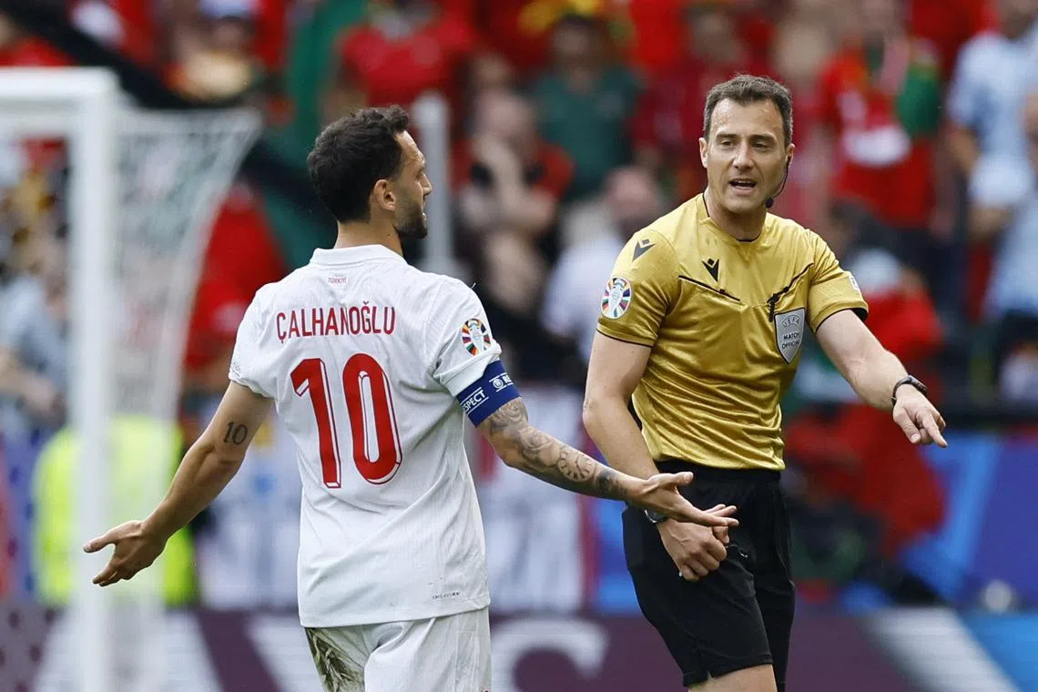 Soccer Football - Euro 2024 - Group F - Turkey v Portugal - Dortmund BVB Stadion, Dortmund, Germany - June 22, 2024 Turkey's Hakan Calhanoglu remonstrates with referee Felix Zwayer REUTERS/Leon Kuegeler/ File Photo