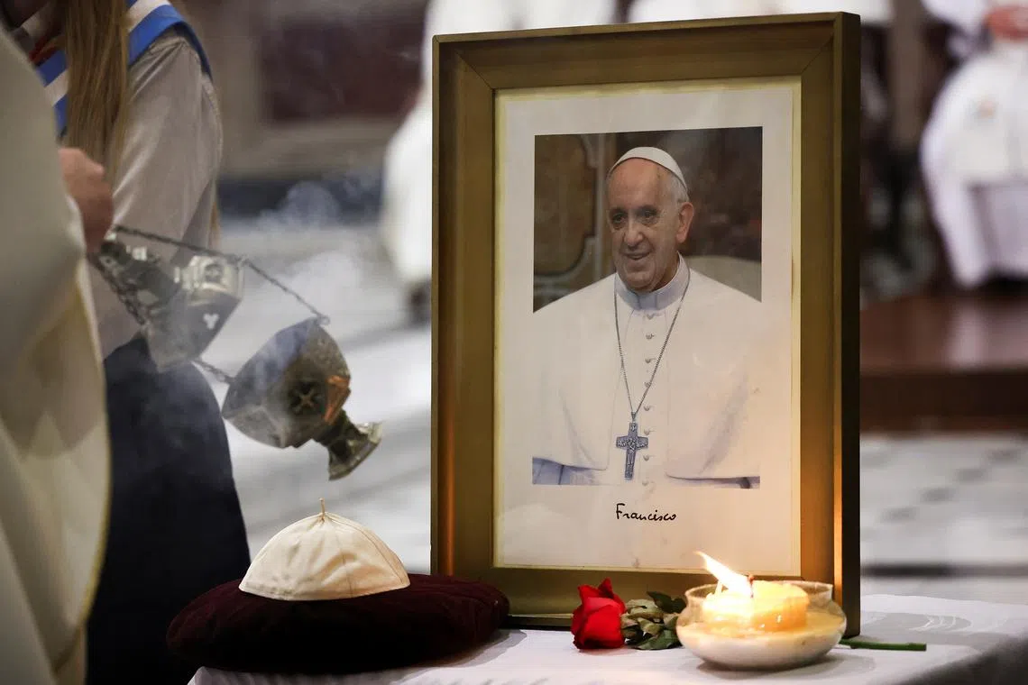 A picture of Pope Francis stands during Mass at Basilica of San Jose de Flores, following the death of the pontiff, in Buenos Aires, Argentina, April 21, 2025. REUTERS/Agustin Marcarian