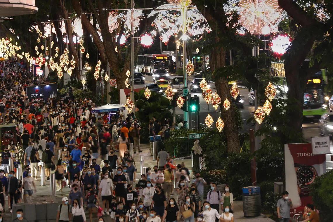 The pre-Christmas shopping rush with crowds and decorations along Orchard Road, taken on 23 Dec 2021.