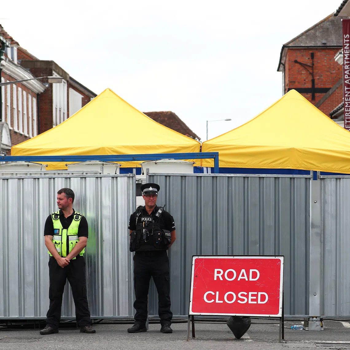 Police officers stand outside the street where Dawn Sturgess lived before dying after being exposed to a Novichok nerve agent, in Salisbury, Britain, July 19, 2018. REUTERS/Hannah McKay