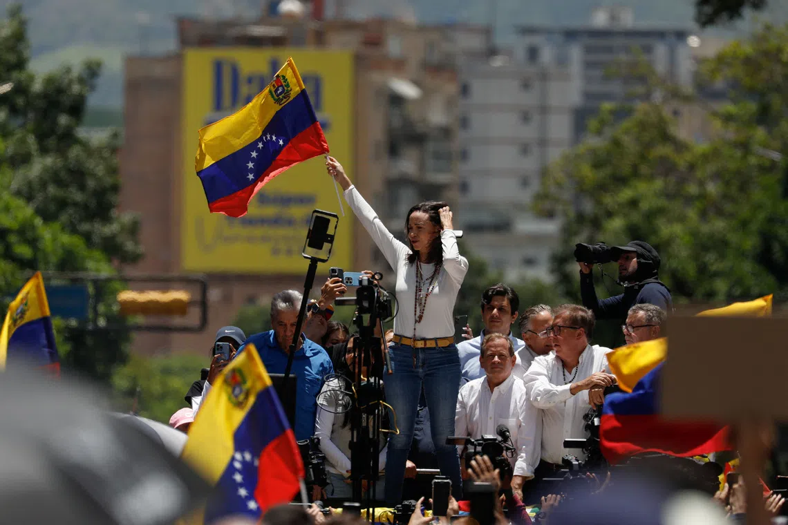 FILE PHOTO: Venezuelan opposition leader Maria Corina Machado waves a flag during a protest against the election results announced by President Nicolas Maduro's government after he was declared winner of the election, in Caracas, Venezuela August 28, 2024. REUTERS/Leonardo Fernandez Viloria/File Photo