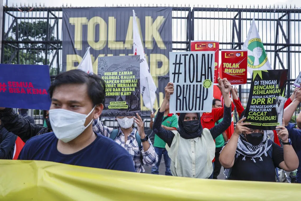 Protesters demonstrating against the draft of the new criminal law outside the parliament building in Jakarta on Dec 5, 2022.
