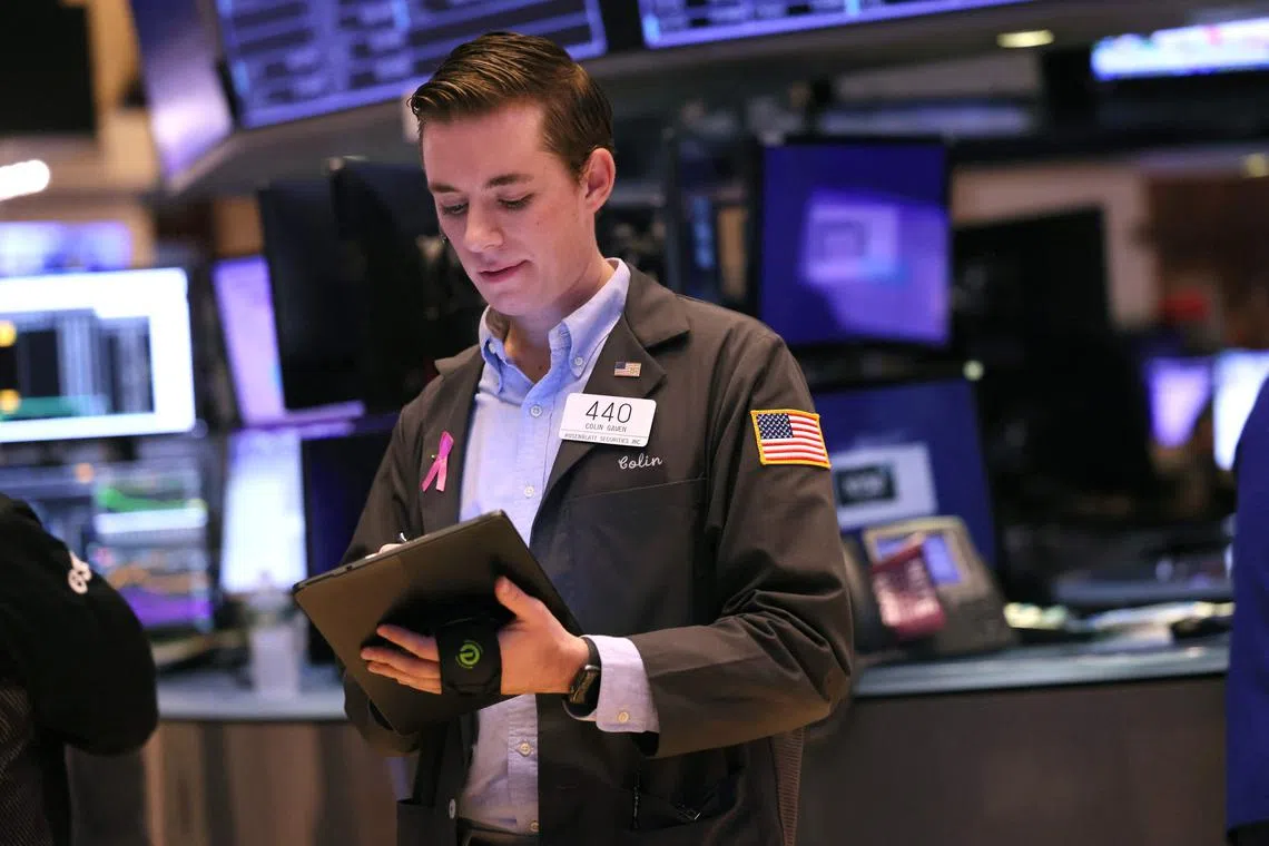 Traders work on the floor of the New York Stock Exchange, in New York City.