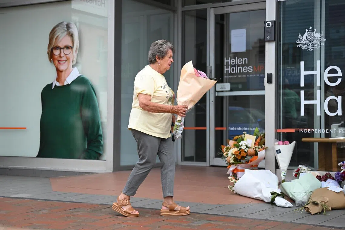A lady with flowers for Independent Australian federal MP Helen Haines outside her electoral office on Oct 20.
