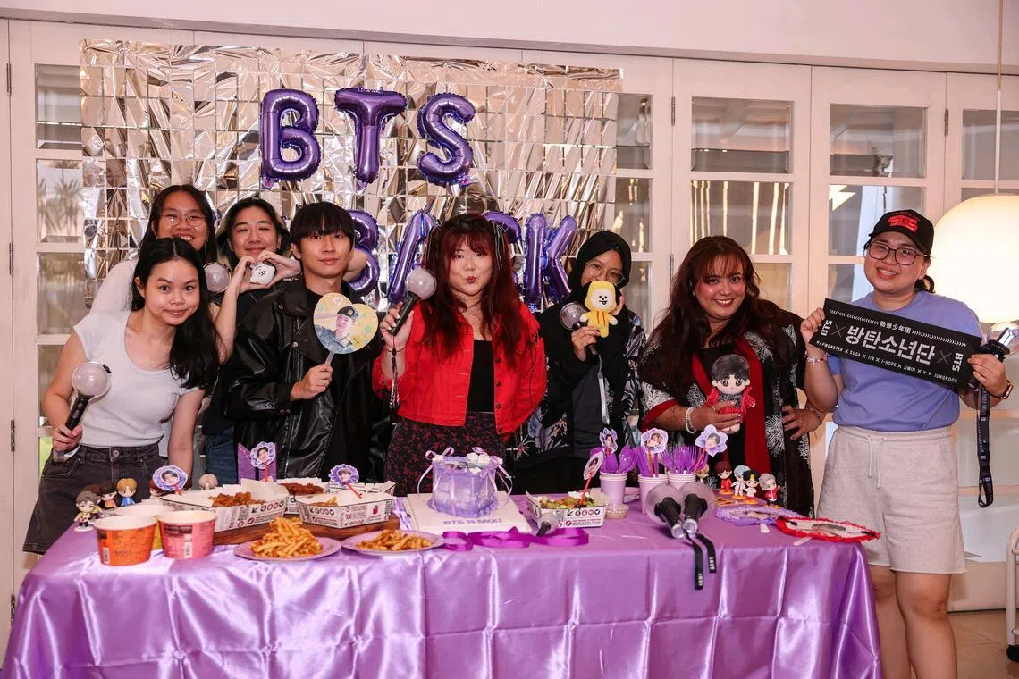 Ms Wee Li Shyen (centre, in red) hosting fellow BTS fans at a semi-detached house in the Bukit Timah area for a watch party of BTS The Comeback Live: Arirang on Netflix on March 21.