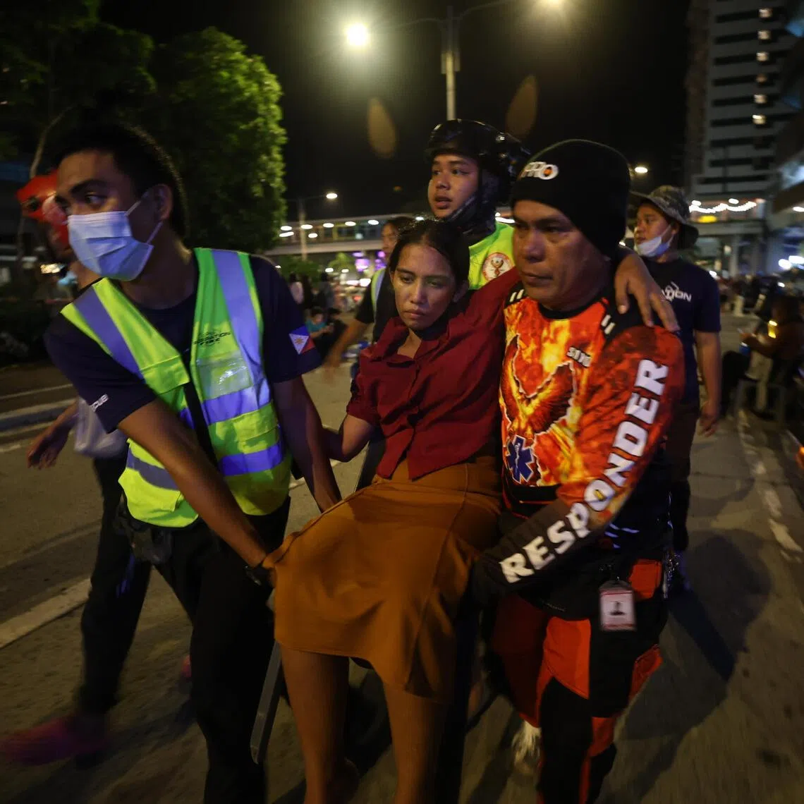 Rescuers carrying an injured woman in Ilo-Ilo city, after an earthquake hit the central Philippines on Sept 30.

