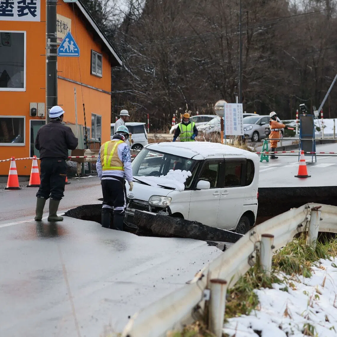 A vehicle is seen on a collapsed road in Tohoku town in Aomori Prefecture, on Dec 9.