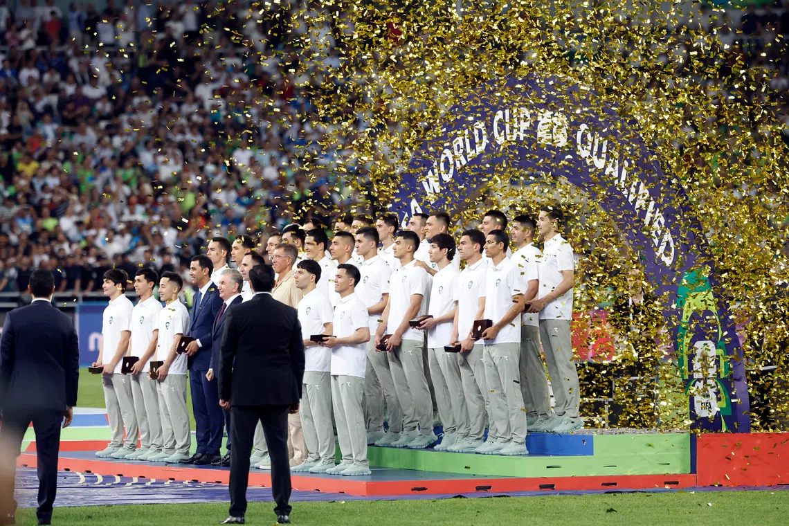 Soccer Football - World Cup - AFC Qualifiers - Group A - Uzbekistan v Qatar - Milliy Stadium, Tashkent, Uzbekistan - June 10, 2025 Uzbekistan President Shavkat Mirziyoyev and players pose for a picture to celebrate securing a spot at the 2026 FIFA World Cup
