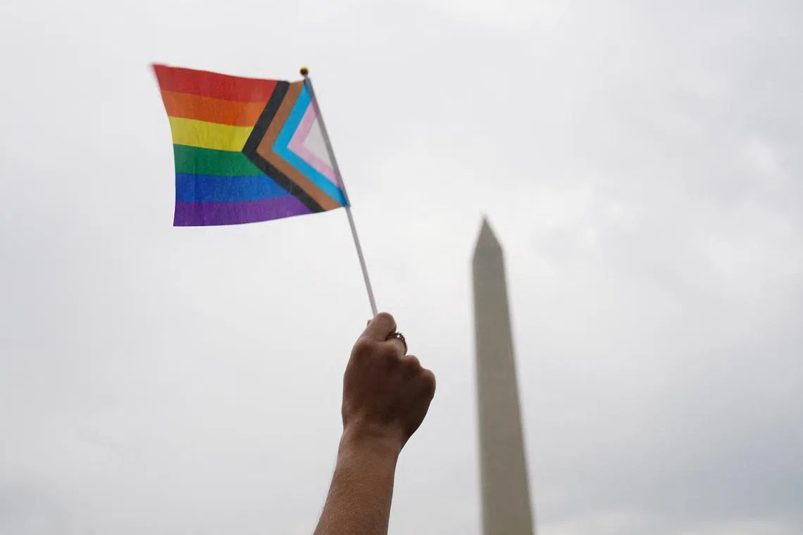 A person holds a Progress Pride Flag during the \"International Rally + March on Washington for Freedom\" in support of LGBTQ+ rights as part of WorldPride in Washington, D.C., U.S., June 8, 2025. REUTERS/Gabriel V. Cardenas