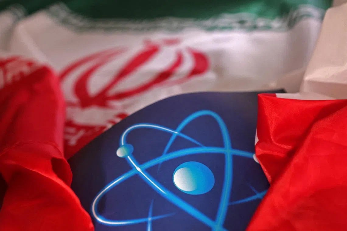 FILE PHOTO: Atomic symbol and Iranian flag are seen in this illustration taken September 8, 2022. REUTERS/Dado Ruvic/Illustration/File Photo