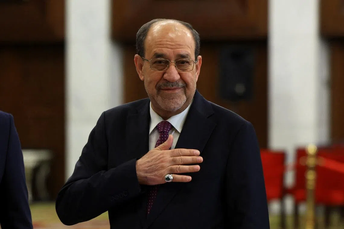 Former Iraqi Prime Minister Nouri al-Maliki reacts at a polling station inside Al-Rasheed Hotel during the parliamentary election in Baghdad, Iraq, November 11, 2025. REUTERS/Thaier Al-Sudani
