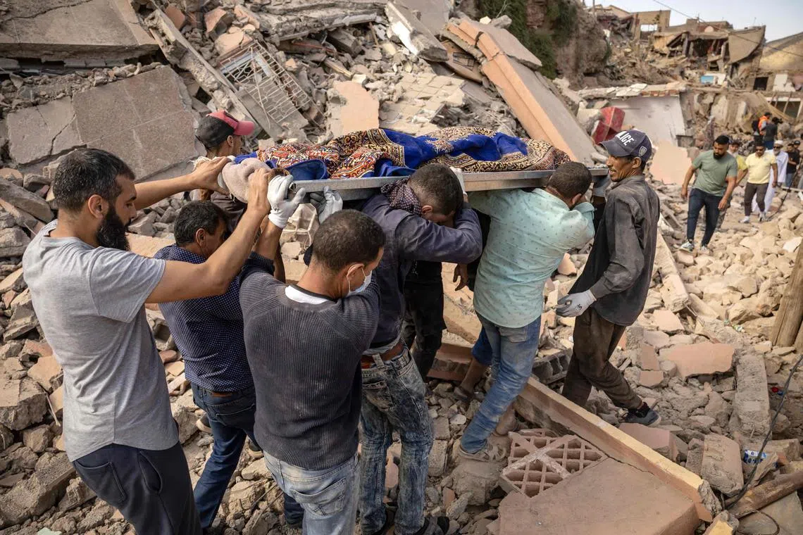 People carrying the remains of a victim of the deadly 6.8-magnitude earthquake, in the village of Imi N'Tala near Amizmiz, in central Morocco, on Sept 10, 2023. 