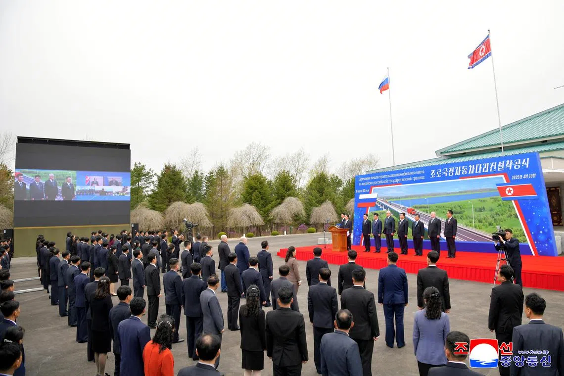 Officials attend a ground-breaking ceremony for a new road bridge spanning the Tumen River that will link North Korea to Russia in Rason Municipality, North Korea, April 30, 2025, in this photo released by North Korea's official Korean Central News Agency. KCNA via REUTERS