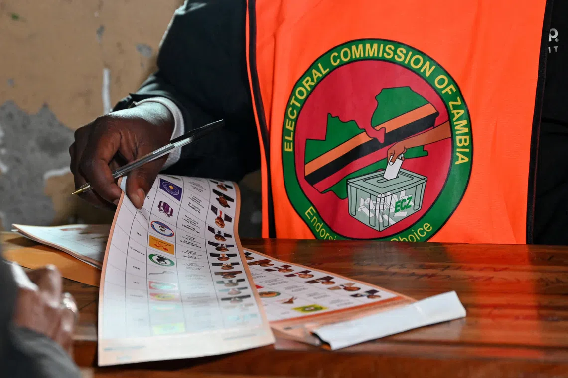 An election official holds a ballot at a polling station during Zambia's general elections, including a presidential election, in Lusaka, Zambia, August 13, 2026. REUTERS/Moses Mwape