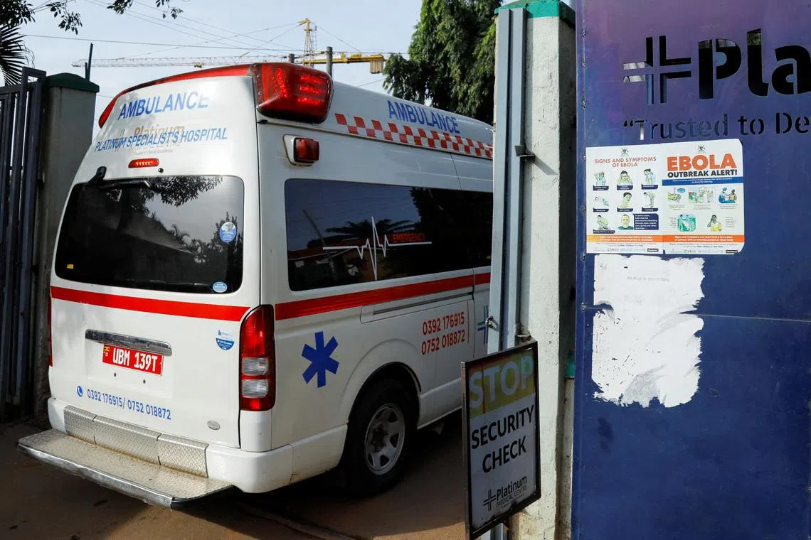 An ambulance drives past an advocacy poster against the spread of the Ebola virus, as aid agencies intensify efforts to contain a new Ebola outbreak involving the Bundibugyo Virus at the Platinum Medical Centre in Kampala, Uganda, May 26, 2026.
