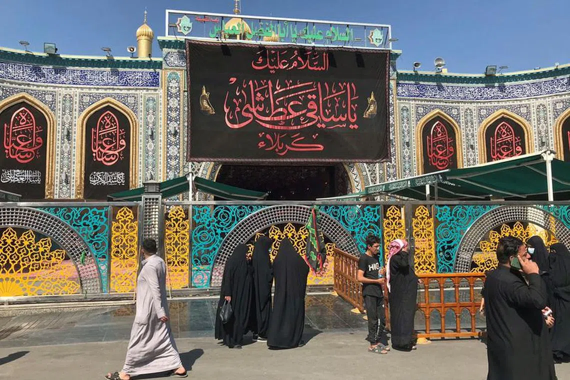 FILE PHOTO: Pilgrims walk past the shrine of the Imam Abbas, adjacent to the Imam Hussein shrine in Kerbala, Iraq September 29, 2020. Picture taken September 29, 2020.    REUTERS/John Davison/File Photo