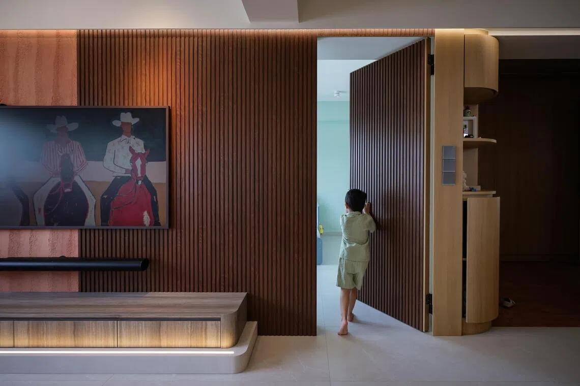 Part of the original living room in Ben Teo and Evadne Loke’s Toa Payoh flat was carved out to create a bedroom for their son, with a concealed door.