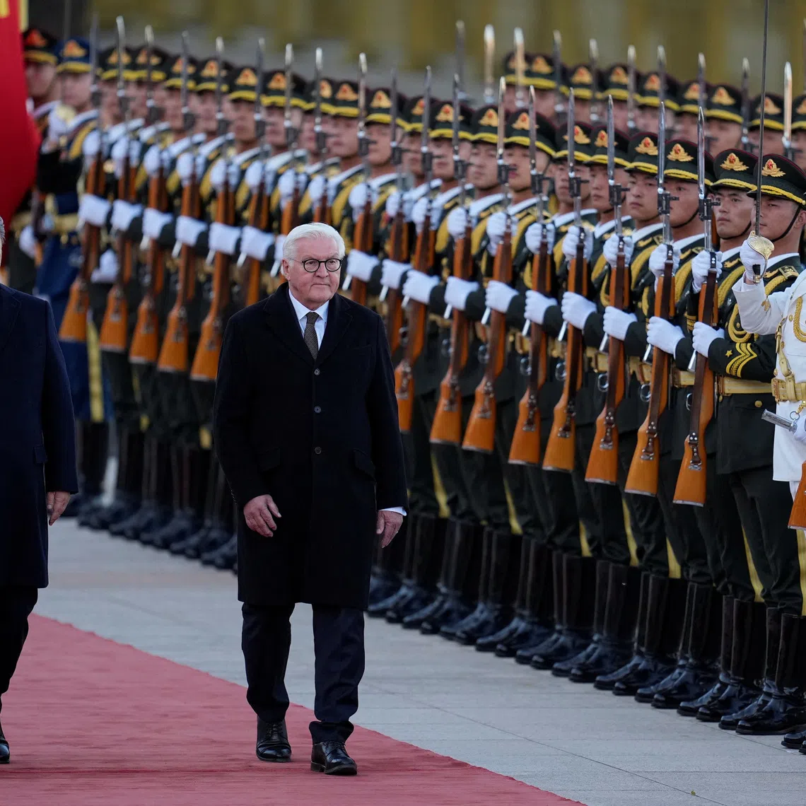 Chinese President Xi Jinping and German President Frank-Walter Steinmeier receive a guard of honor during a welcoming ceremony outside the Great Hall of the People in Beijing, China, October 30, 2026. KYODO NEWS/Kai Naito/Pool via REUTERS