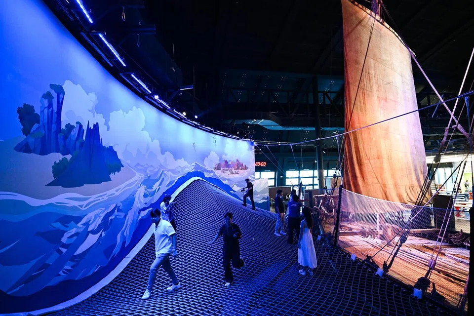 A suspended web structure offering views of a ship replica