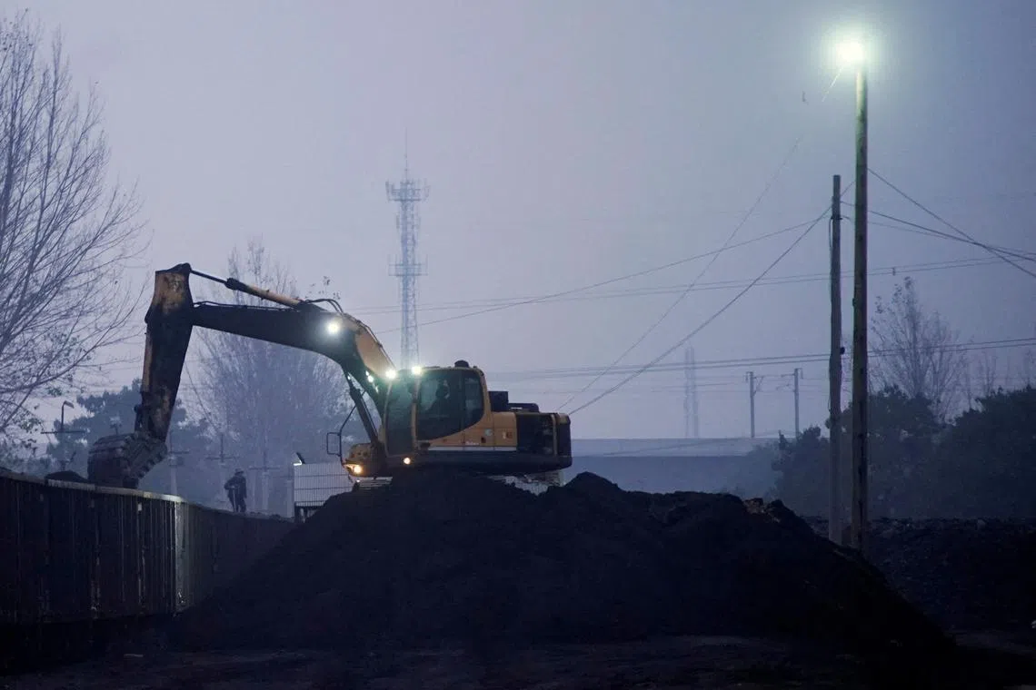 An excavator loading coal onto a train in Pingdingshan, Henan province, China on Friday.  Around 40 per cent of China’s methane emissions are gas that escapes during the mining of coal.