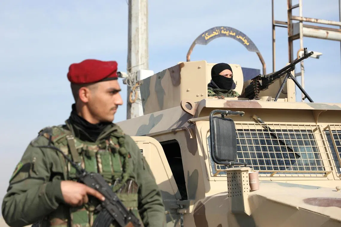 FILE PHOTO: A member of Kurdish-led Syrian Democratic Forces (SDF) stands along a street, after rebels seized the capital and ousted Syria's Bashar al-Assad, in Hasakah, Syria December 11, 2024. REUTERS/Orhan Qereman/File Photo