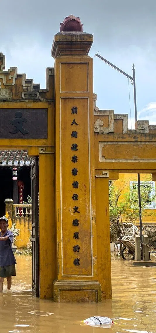 A man wades through a flooded area in Hoi An, following deadly floods in central Vietnam, October 31, 2025. REUTERS/Thinh Nguyen