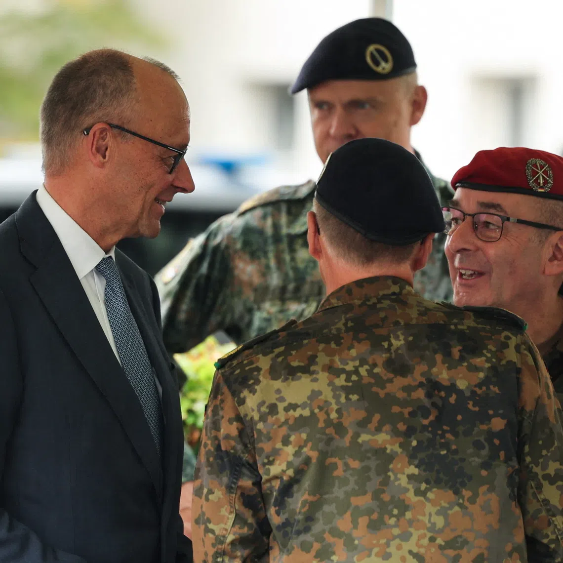 German Chancellor Friedrich Merz speaks with Carsten Breuer, Inspector General of the Bundeswehr as he visits the 1 German-Netherlands Corps (1GNC) in Muenster, Germany, October 1, 2026. REUTERS/Leon Kuegeler