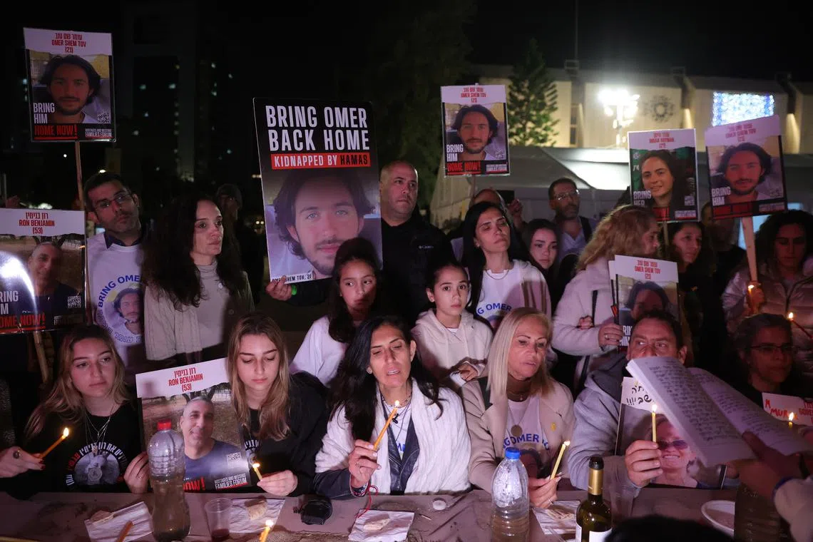 Families of hostages held by Hamas in Gaza light candles during protest outside the Kirya military base in Tel Aviv.