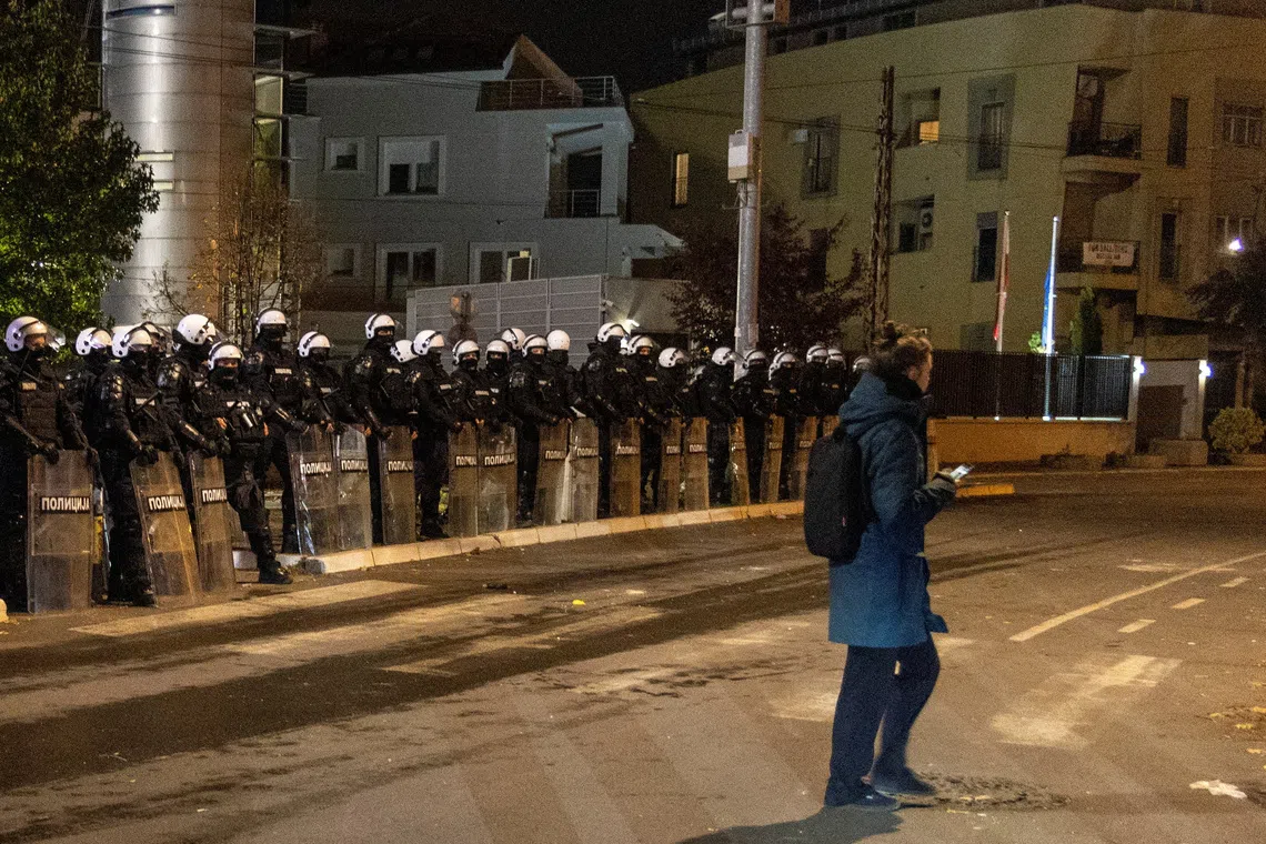 Riot police officers stand guard in front of the TV Pink building in Belgrade, Serbia, October 26, 2026. REUTERS/Djordje Kojadinovic
