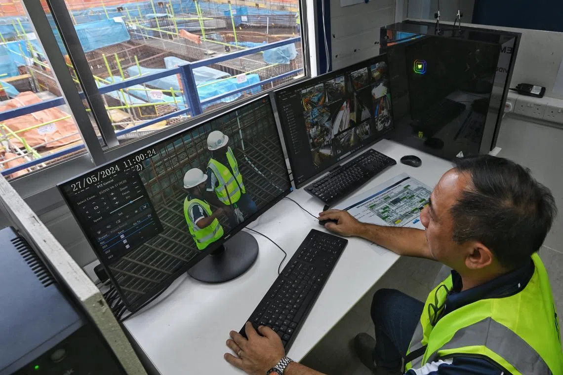 Mr Charles Cruz, 51, an interface engineer from Zheng Keng Engineering and Construction, checks a video surveillance system at the Serangoon Polyclinic construction worksite. The system automatically detects safety breaches and sends an alert to supervisors.