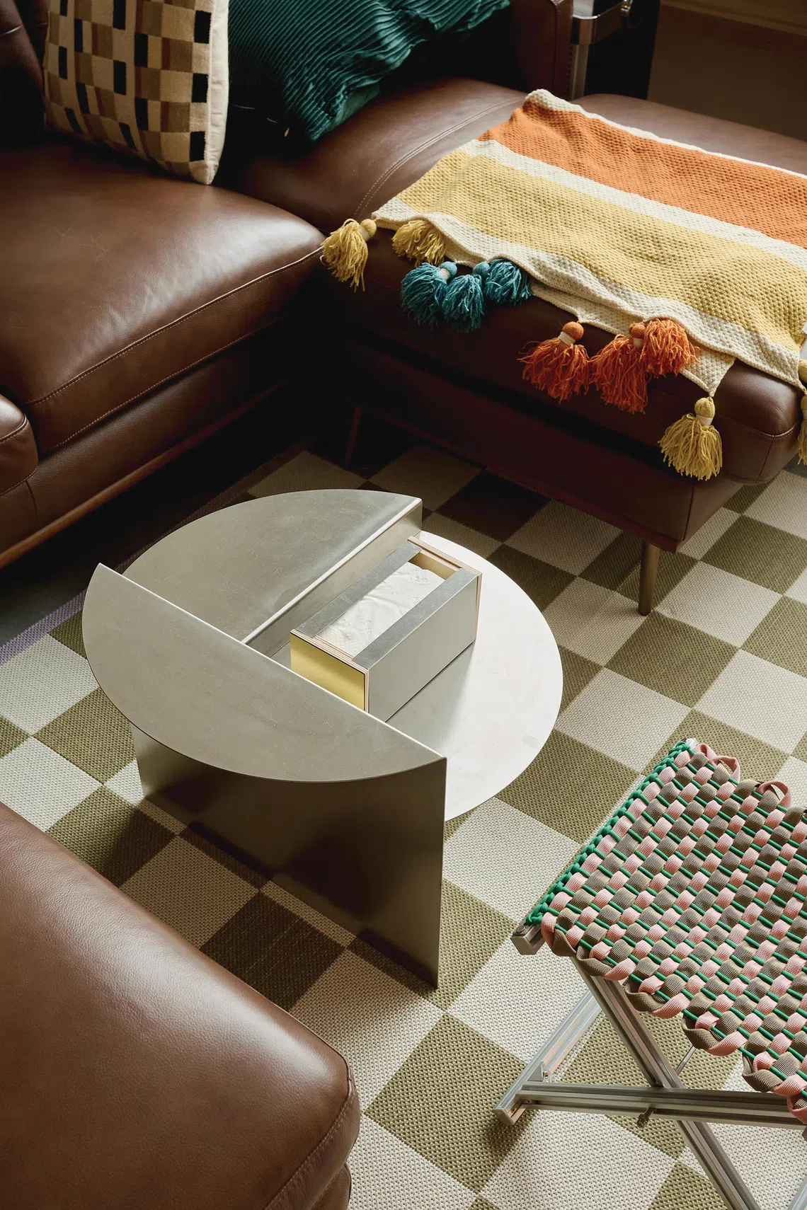 An abstract coffee table sits among colourful textiles in the living area.
