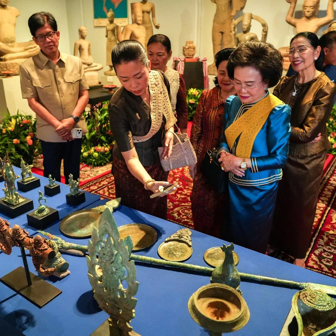 People attend a ceremony for the return of 74 Khmer cultural objects to Cambodia.