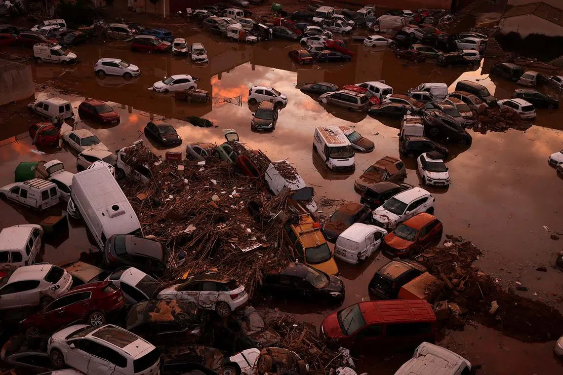 Cars and debris piled on a street in the aftermath of floods caused by heavy rains in Paiporta, near Valencia, Spain, Nov 5, 2024. 