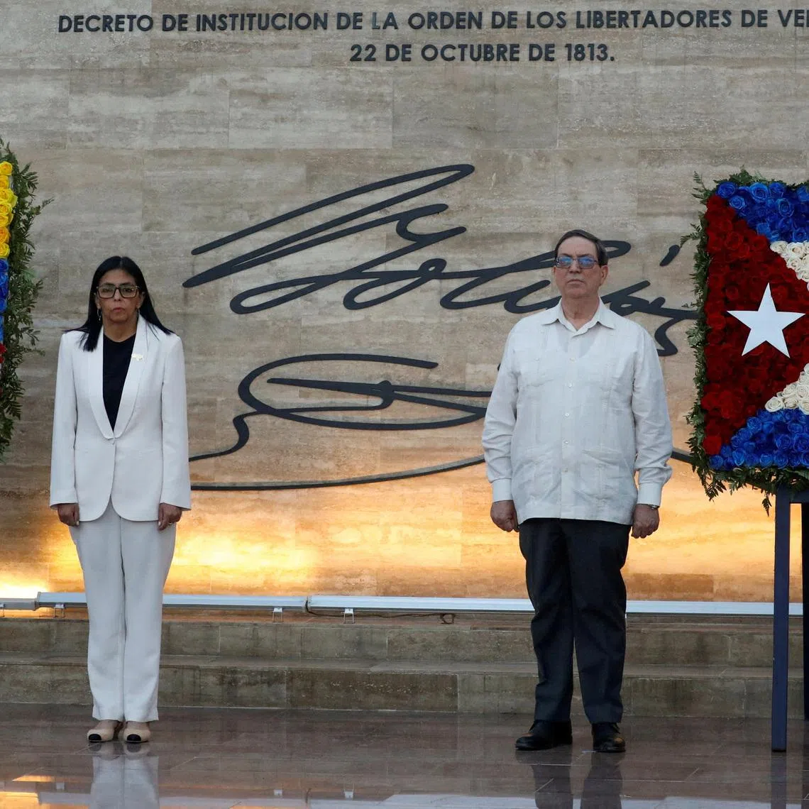 FILE PHOTO: Venezuela's interim president Delcy Rodriguez and Cuban Foreign Minister, Bruno Rodriguez Padilla attend the ceremony \"Promotions and Decorations for Heroes and Martyrs\", honouring Venezuelan and Cuban military and security personnel who died during a U.S. operation to capture Venezuela's President Nicolas Maduro and his wife Cilia Flores, in Caracas, Venezuela January 8, 2026. REUTERS/Leonardo Fernandez Viloria/File Photo