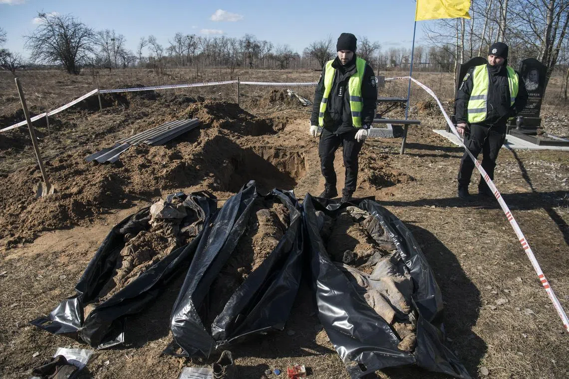 Ukrainian policemen exhume three bodies of people who were killed during the Russian occupation of the city of Borodyanka, Ukraine.