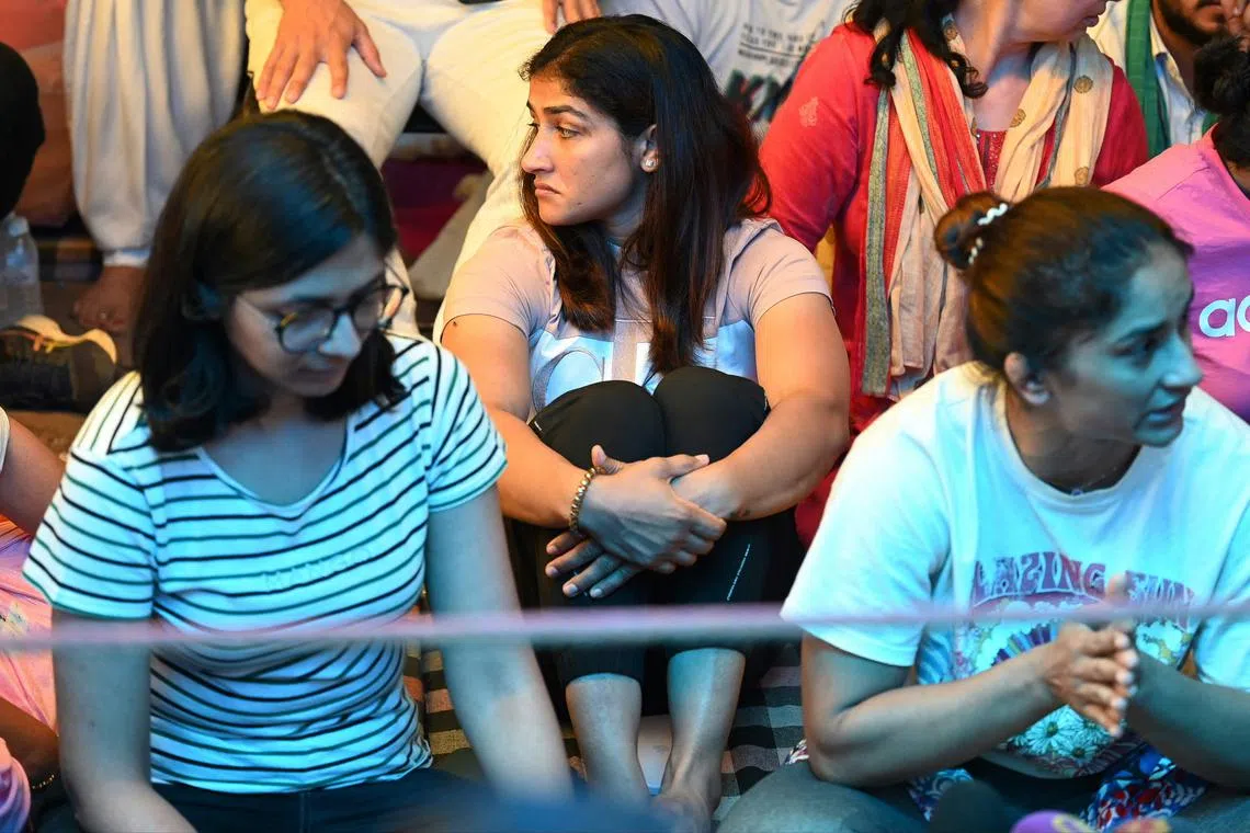 CORRECTION / Indian wrestlers Sangita Phogat (C), Vinesh Phogat (R) along with Chairperson of the Delhi Commission for Women Swati Maliwal (L) take part in an ongoing protest with other wrestlers against the Wrestling Federation of India (WFI) in New Delhi on May 4, 2023, following allegations of sexual harassment to athletes by members of the WFI. (Photo by Money SHARMA / AFP) / “The erroneous mention[s] appearing in the metadata of this photo by Money SHARMA has been modified in AFP systems in the following manner: [May] instead of [April]. Please immediately remove the erroneous mention[s] from all your online services and delete it (them) from your servers. If you have been authorized by AFP to distribute it (them) to third parties, please ensure that the same actions are carried out by them. Failure to promptly comply with these instructions will entail liability on your part for any continued or post notification usage. Therefore we thank you very much for all your attention and prompt action. We are sorry for the inconvenience this notification may cause and remain at your disposal for any further information you may require.”