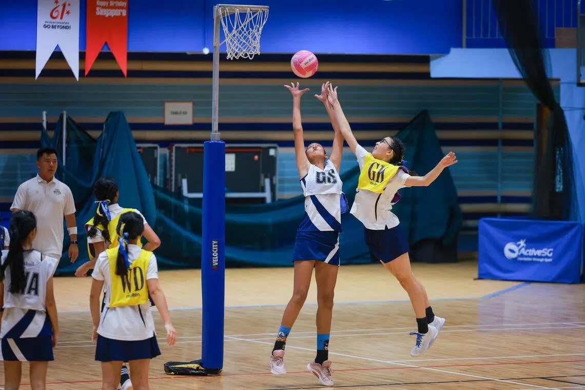CHIJ Secondary (Toa Payoh)’s 1.9m-tall Naomi Pathman (middle) towered over Methodist Girls’ School’s Chloe Ma (right) in the C Division Netball final at Jurong East Sports Hall.