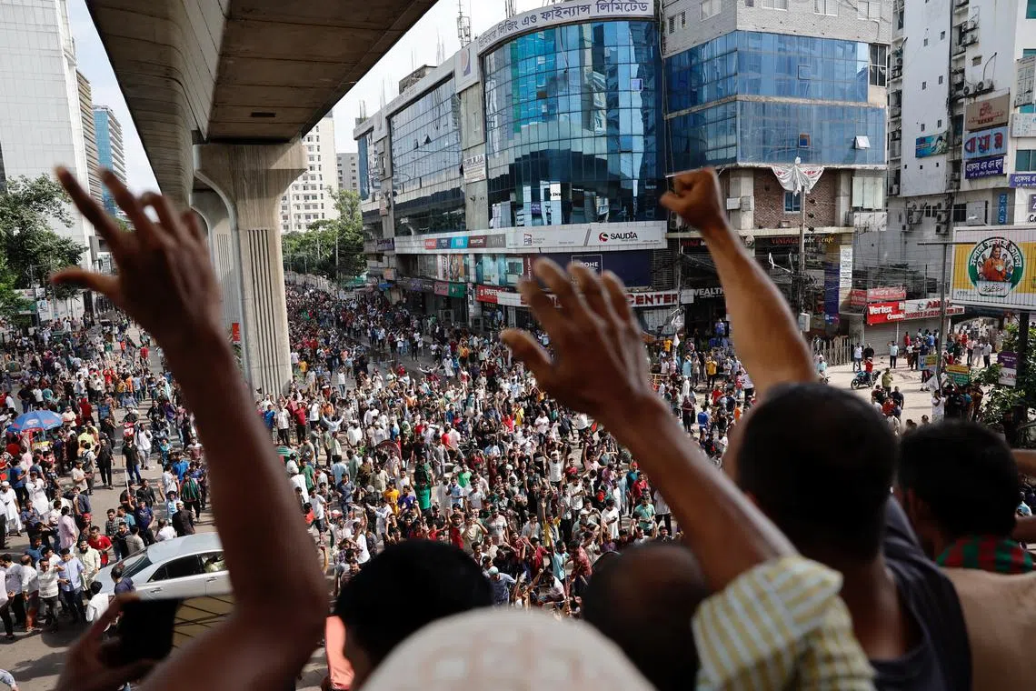 FILE PHOTO: People wave hands as they celebrate the resignation of Prime Minister Sheikh Hasina in Dhaka, Bangladesh, August 5, 2024. REUTERS/Mohammad Ponir Hossain/File Photo