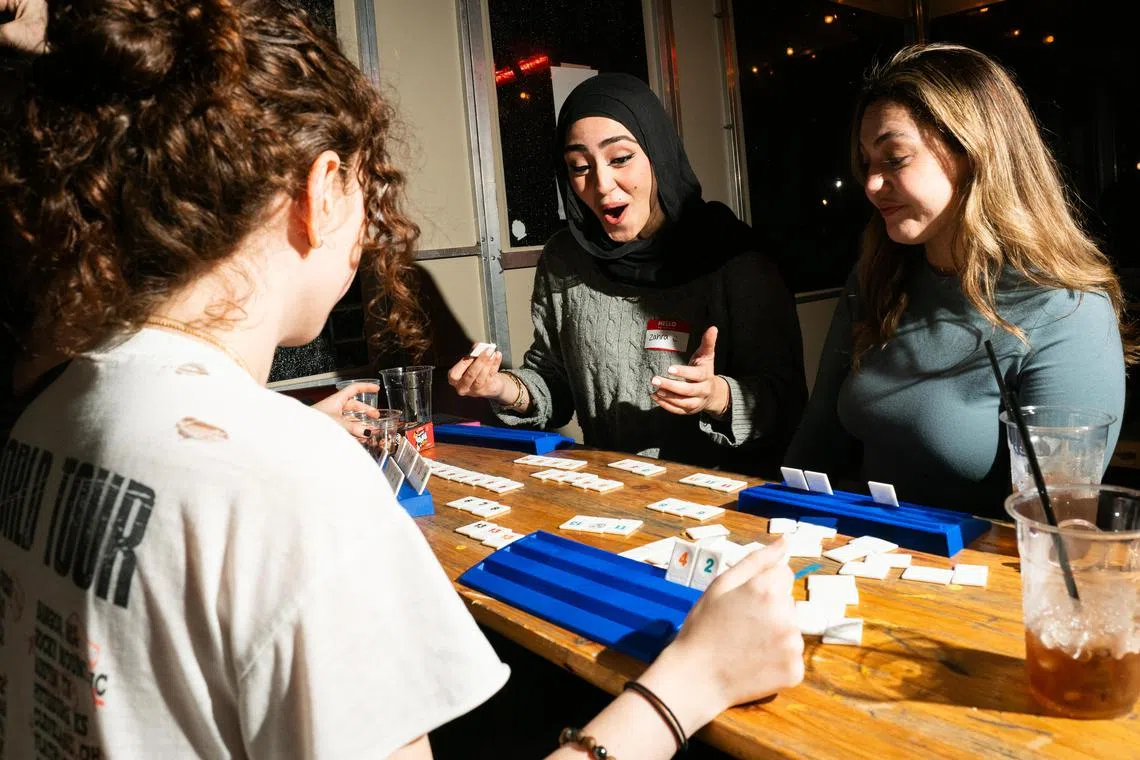 As a DJ played music, board gamers play Rummikub during a meet-up in Brooklyn's Williamsburg neighbourhood on Dec 10, 2024.  