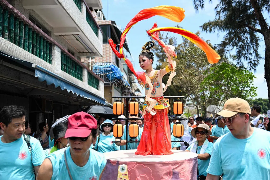 A child participating in the "Piu Sik" parade on the island of Cheung Chau during its annual Bun festival in Hong Kong, on May 5, 2025. 